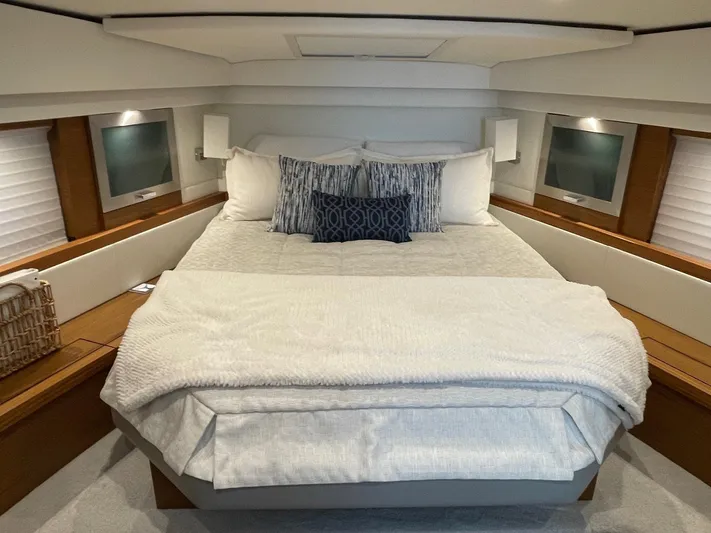 Salty Suite Yacht Photos Pics Luxurious bedroom in 2023 Tiara Yachts C44 Coupe with cozy bedding and modern design.