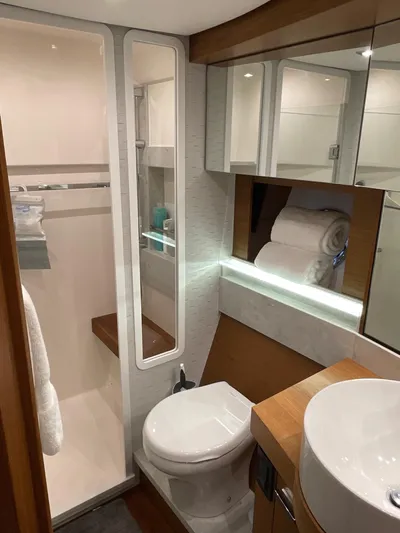 Salty Suite Yacht Photos Pics 2023 Tiara Yachts C44 Coupe bathroom with modern amenities and sleek design.