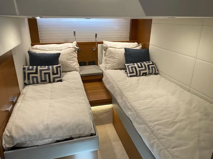 Salty Suite Yacht Photos Pics 2023 Tiara Yachts C44 Coupe twin bed cabin with modern decor and plush bedding.
