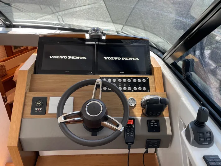 Salty Suite Yacht Photos Pics 2023 Tiara Yachts C44 Coupe helm with Volvo Penta controls and dual displays.
