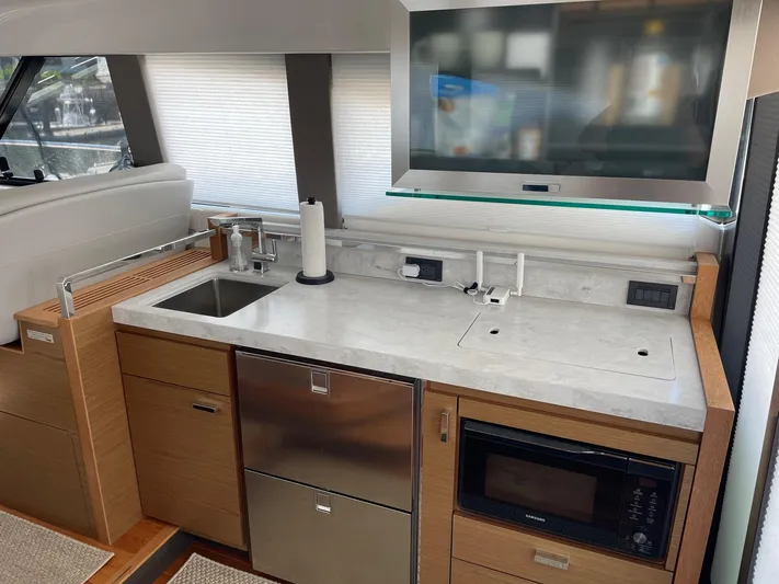 Salty Suite Yacht Photos Pics Modern kitchen area in 2023 Tiara Yachts C44 Coupe with stainless steel appliances.