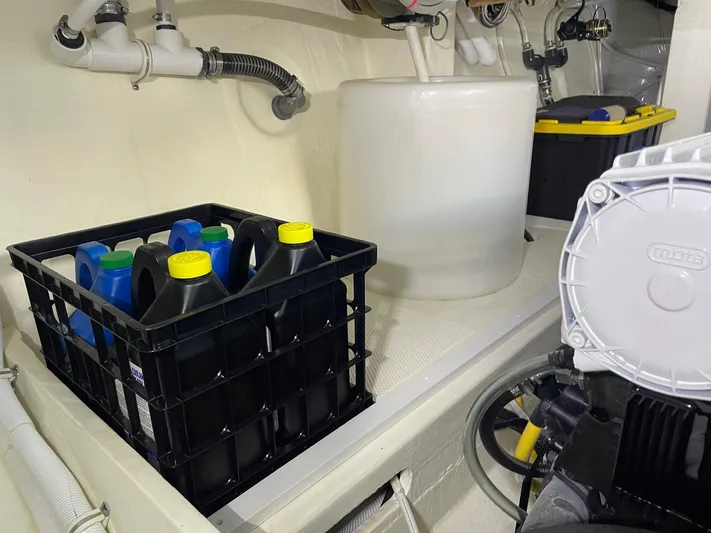 Salty Suite Yacht Photos Pics Engine room of 2023 Tiara Yachts C44 Coupe with oil containers and equipment.
