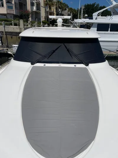 Salty Suite Yacht Photos Pics 2023 Tiara Yachts C44 Coupe with covered windshield and deck, docked at marina.