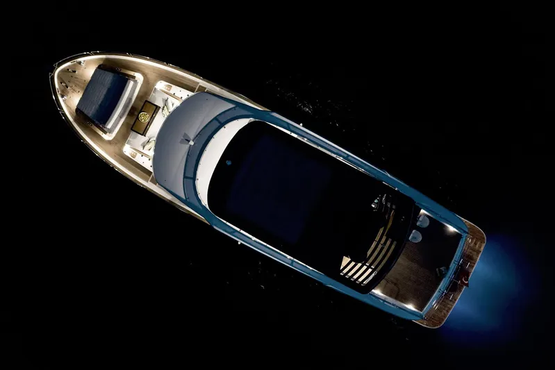  Yacht Photos Pics Aerial view of 2024 Sirena 68 yacht illuminated at night, showcasing sleek design and luxury features.