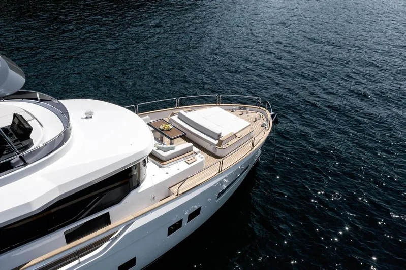  Yacht Photos Pics 2024 Sirena 68 yacht on calm blue water, showcasing sleek design and luxury deck features.