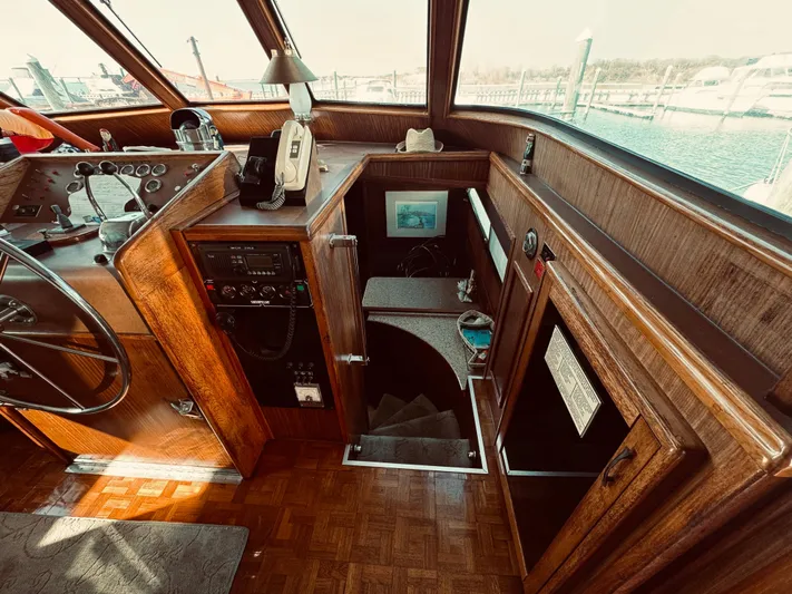 Carol Ann Yacht Photos Pics 1984 Hatteras 53 Extended Deckhouse Motor Yacht interior with helm and wooden finishes.