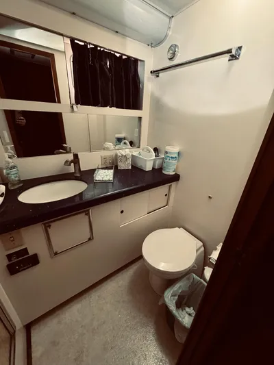 Carol Ann Yacht Photos Pics Bathroom interior of 1984 Hatteras 53 Extended Deckhouse Motor Yacht, featuring sink and toilet.