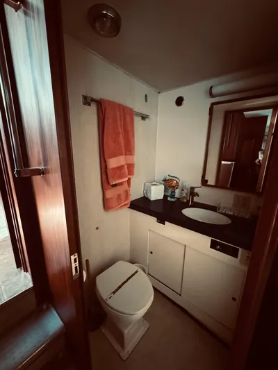 Carol Ann Yacht Photos Pics 1984 Hatteras 53 Motor Yacht bathroom with sink, mirror, and towel.