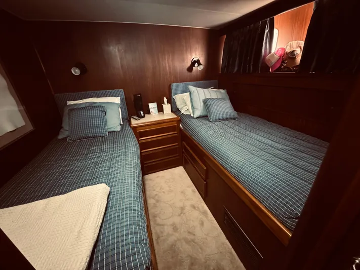 Carol Ann Yacht Photos Pics Interior of 1984 Hatteras 53 Motor Yacht with twin beds and wood paneling.
