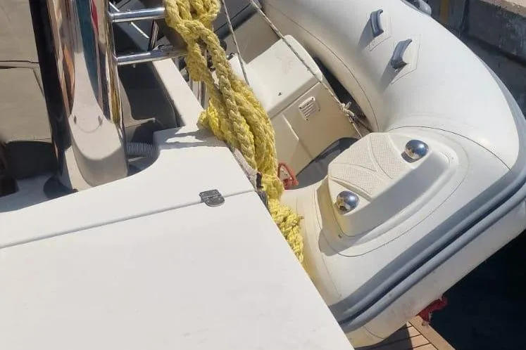  Yacht Photos Pics Inflatable boat docked, featuring yellow rope and sleek design, Bali 5.4 model, 2019.