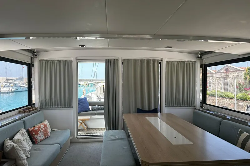  Yacht Photos Pics Interior of 2019 Bali 5.4 catamaran with elegant seating and dining area, marina view.