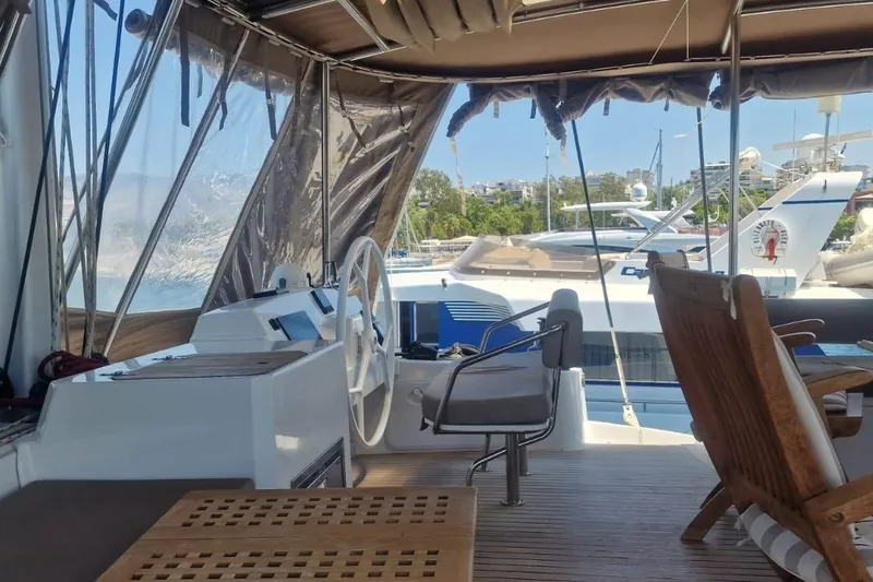  Yacht Photos Pics Interior view of a 2019 Bali 5.4 yacht with helm and seating area.