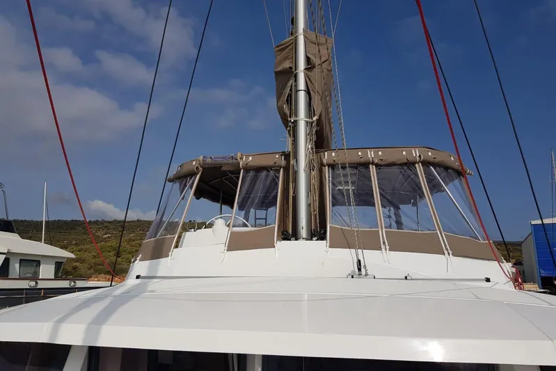  Yacht Photos Pics 2019 Bali 5.4 catamaran with covered cockpit, docked under clear blue sky.