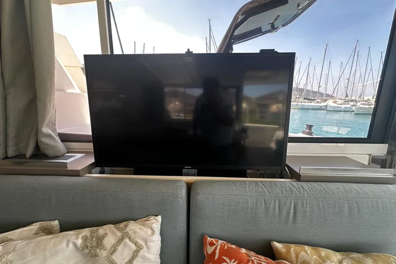  Yacht Photos Pics Luxurious Bali 5.4 yacht interior with TV, cushions, and marina view, 2019 model.