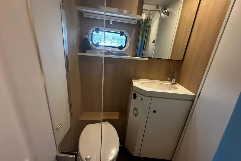  Yacht Photos Pics Compact bathroom in 2019 Bali 5.4 yacht with sink, toilet, and porthole window.