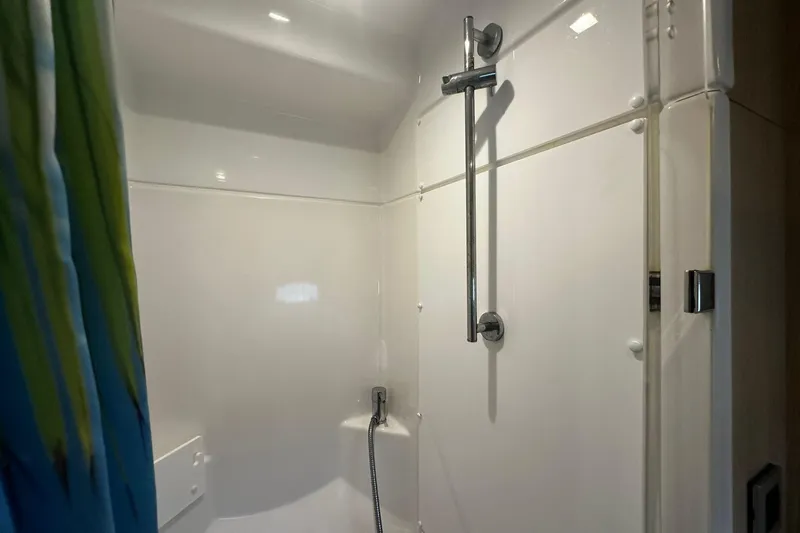  Yacht Photos Pics Modern shower area in 2019 Bali 5.4 model, featuring sleek fixtures and a vibrant curtain.