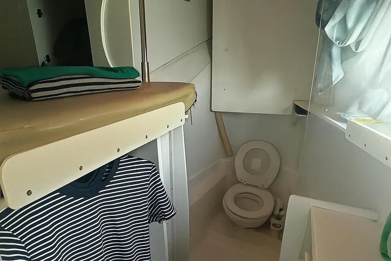  Yacht Photos Pics Compact bathroom in a 2019 Bali 5.4 model, featuring a toilet and storage space.