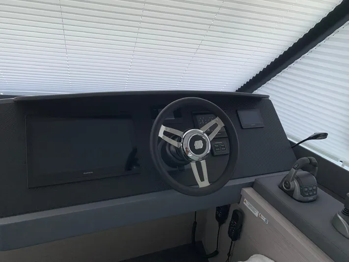  Yacht Photos Pics 2024 Fountaine Pajot MY5 helm with modern steering wheel and navigation controls.
