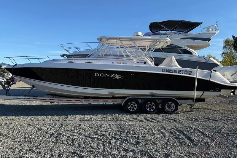  Yacht Photos Pics 2004 Donzi 38 ZSF boat on trailer, black and white design, parked outdoors.