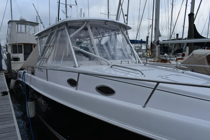  Yacht Photos Pics 2004 Donzi 38 ZSF boat docked at a marina, featuring sleek design and clear canopy.