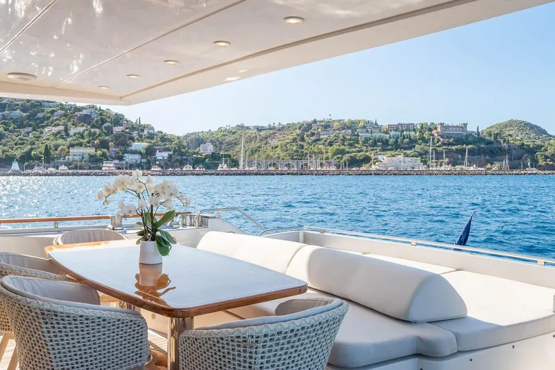 Lady Emma Yacht Photos Pics Luxurious 2007 Guy Couach 3300 Fly yacht with elegant deck and scenic coastal view.