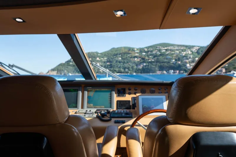 Lady Emma Yacht Photos Pics Interior view of 2007 Guy Couach 3300 Fly yacht cockpit with scenic ocean backdrop.