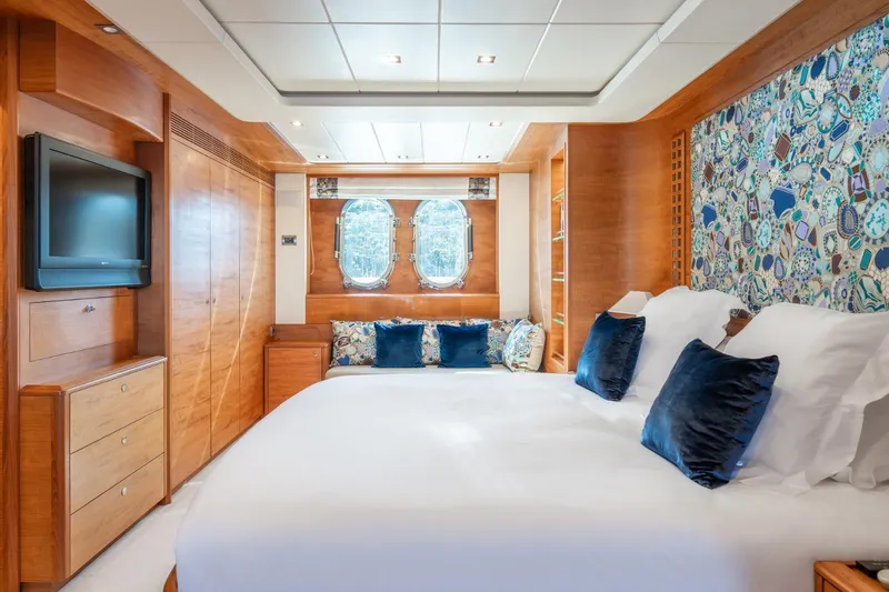 Lady Emma Yacht Photos Pics Luxurious bedroom interior of 2007 Guy Couach 3300 Fly yacht with elegant wood finishes.