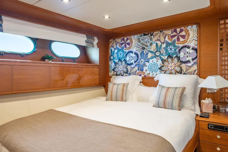 Lady Emma Yacht Photos Pics Luxurious bedroom interior on 2007 Guy Couach 3300 Fly yacht, featuring elegant decor and cozy bedding.