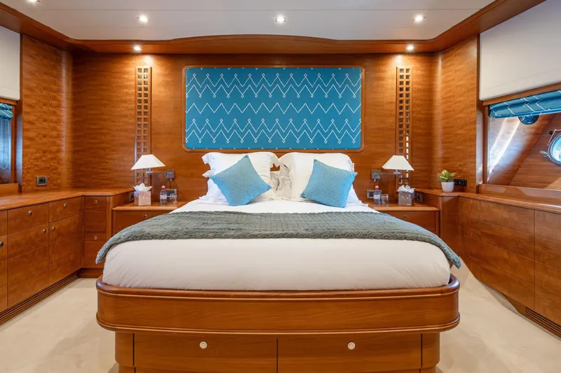 Lady Emma Yacht Photos Pics Luxurious bedroom interior on 2007 Guy Couach 3300 Fly yacht, featuring elegant wood finishes.