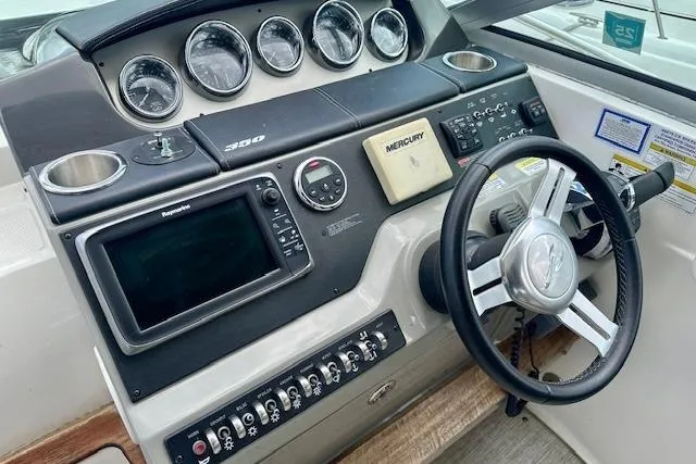  Yacht Photos Pics 2014 Sea Ray 350 Sundancer helm with gauges, steering wheel, and navigation controls.