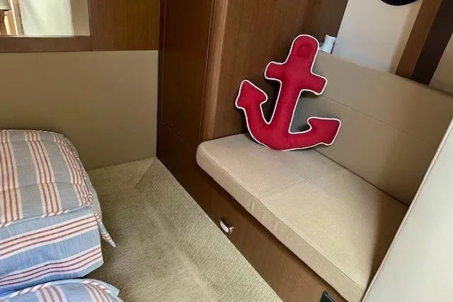  Yacht Photos Pics Interior of 2014 Sea Ray 350 Sundancer with anchor pillow and striped bedding.