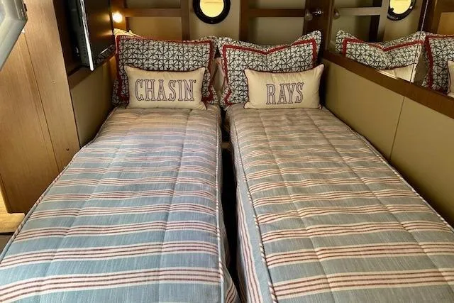  Yacht Photos Pics Interior of 2014 Sea Ray 350 Sundancer with twin beds and nautical-themed pillows.