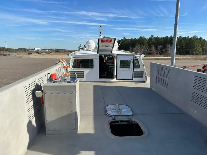  Yacht Photos Pics Custom 64 Crew Boat, 2018 model, docked with open hatch and clear blue sky.