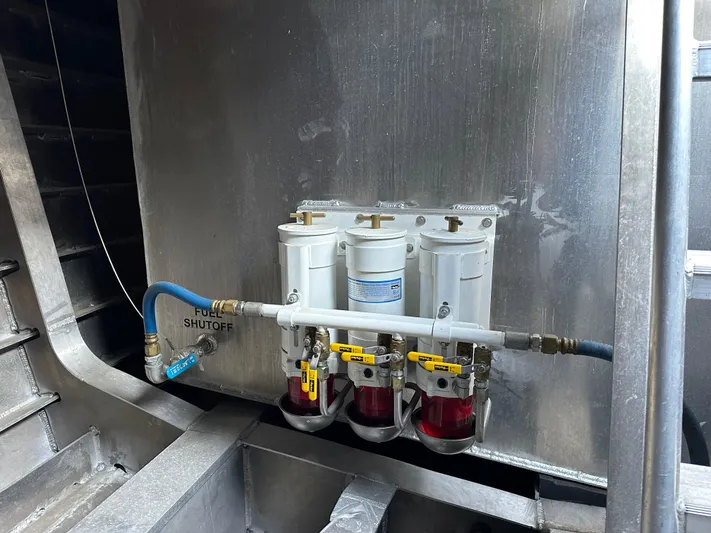  Yacht Photos Pics Fuel filtration system on a 2018 Custom 64 Crew Boat, featuring multiple filters and shutoff valve.
