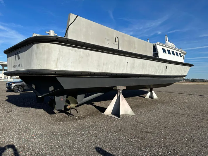  Yacht Photos Pics 2018 Custom 64 Crew Boat on land, gray hull, clear sky background.