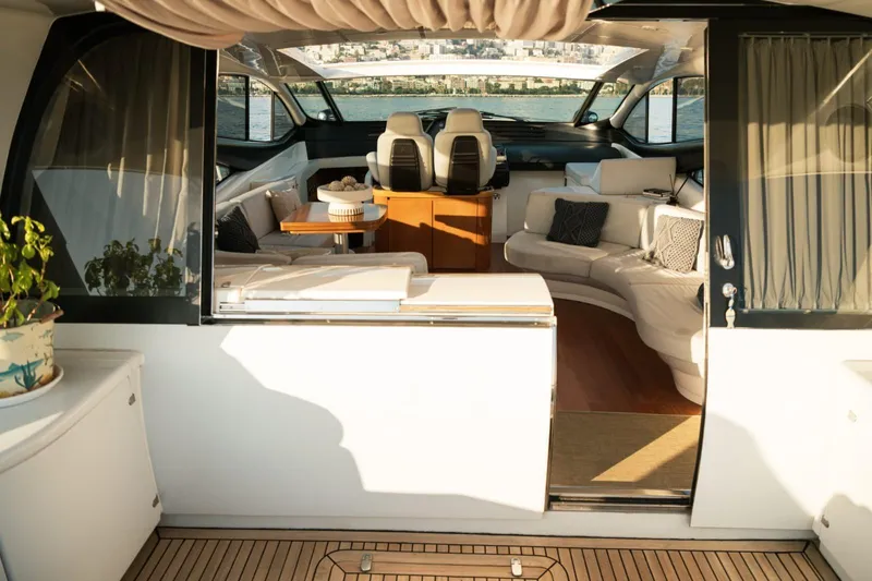 Notorious Yacht Photos Pics Luxurious interior of a 2005 Pershing 62 HT yacht with elegant seating and decor.