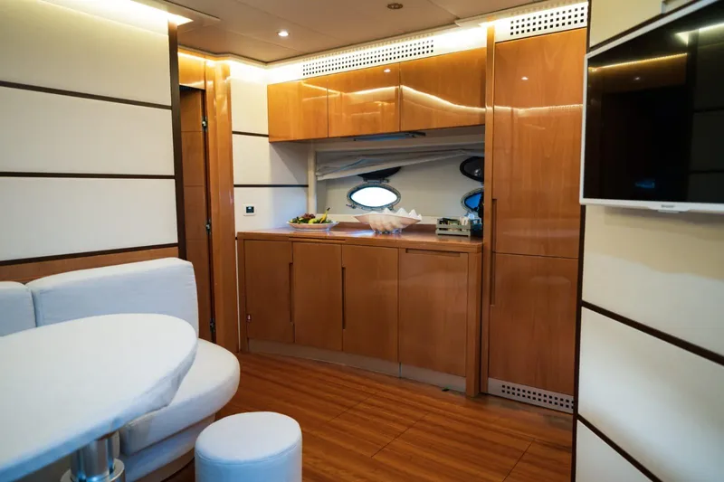 Notorious Yacht Photos Pics Luxurious interior of 2005 Pershing 62 HT yacht with modern wood finishes.