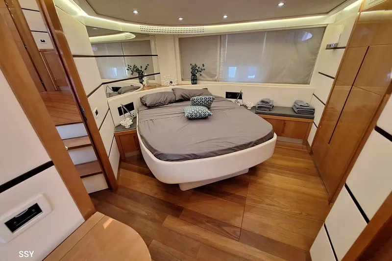 Notorious Yacht Photos Pics Luxurious bedroom interior of 2005 Pershing 62 HT yacht with modern design and wood flooring.