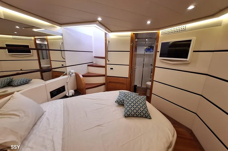 Notorious Yacht Photos Pics Luxurious 2005 Pershing 62 HT yacht bedroom with modern decor and cozy bedding.