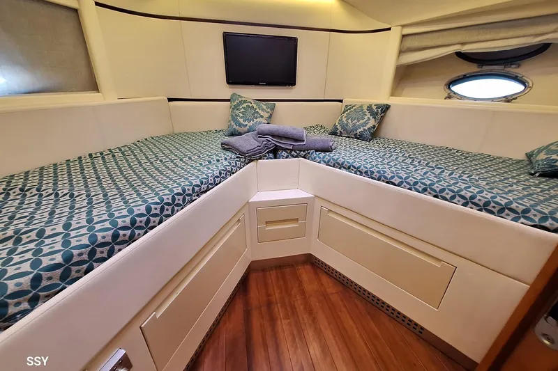 Notorious Yacht Photos Pics Luxurious cabin interior of 2005 Pershing 62 HT yacht with patterned bedding.