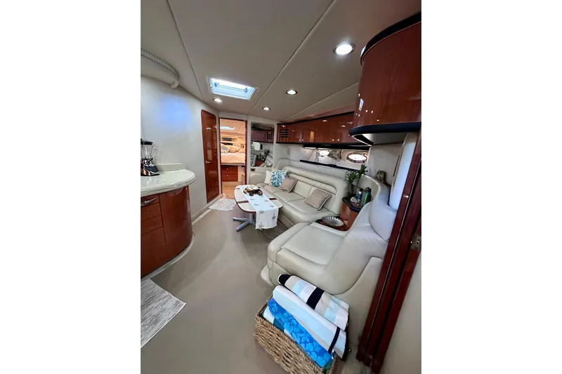  Yacht Photos Pics Luxurious interior of 1999 Sea Ray 460 Sundancer yacht with elegant seating and modern amenities.