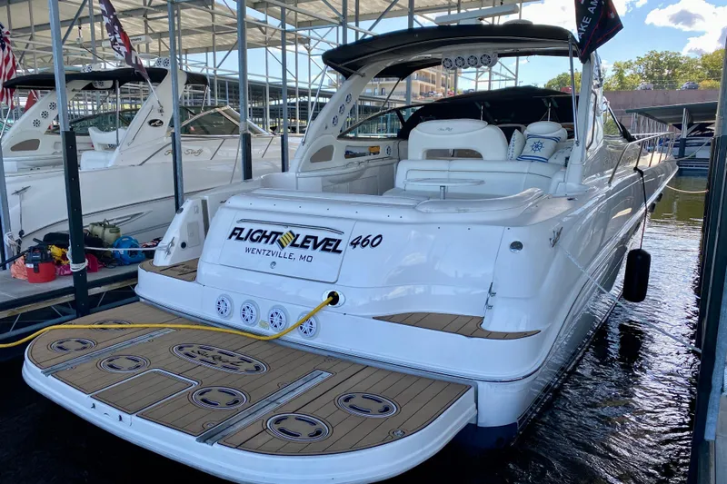  Yacht Photos Pics 1999 Sea Ray 460 Sundancer yacht docked, featuring spacious deck and elegant design.