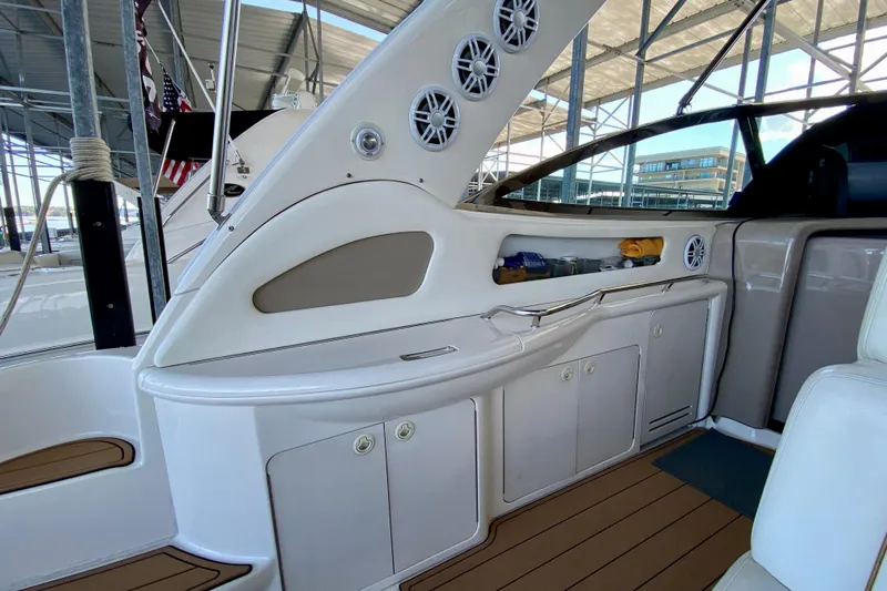  Yacht Photos Pics 1999 Sea Ray 460 Sundancer interior with storage cabinets and speakers in a marina setting.