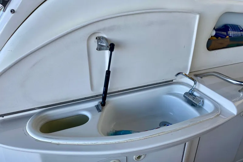  Yacht Photos Pics 1999 Sea Ray 460 Sundancer boat sink with faucet and storage compartment.