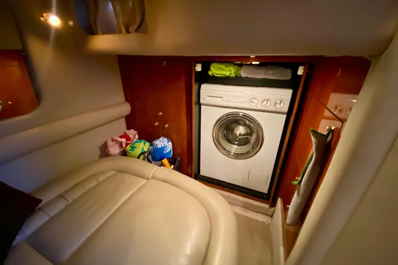  Yacht Photos Pics 1999 Sea Ray 460 Sundancer interior with washing machine and storage space.