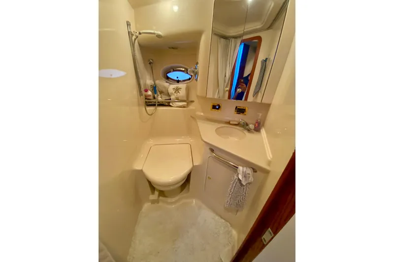  Yacht Photos Pics Bathroom interior of 1999 Sea Ray 460 Sundancer yacht, featuring compact design and amenities.