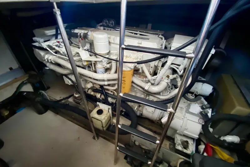  Yacht Photos Pics Engine room of a 1999 Sea Ray 460 Sundancer with visible machinery and ladder.