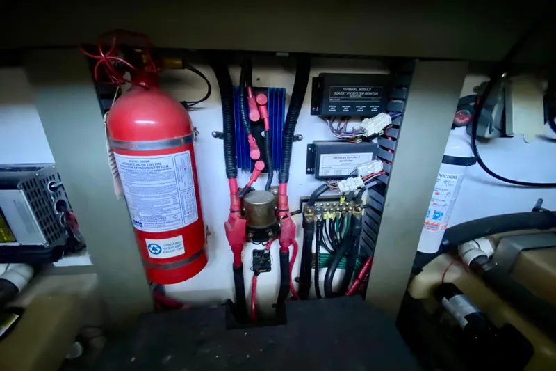  Yacht Photos Pics Engine room of 1999 Sea Ray 460 Sundancer with fire extinguisher and electrical components.