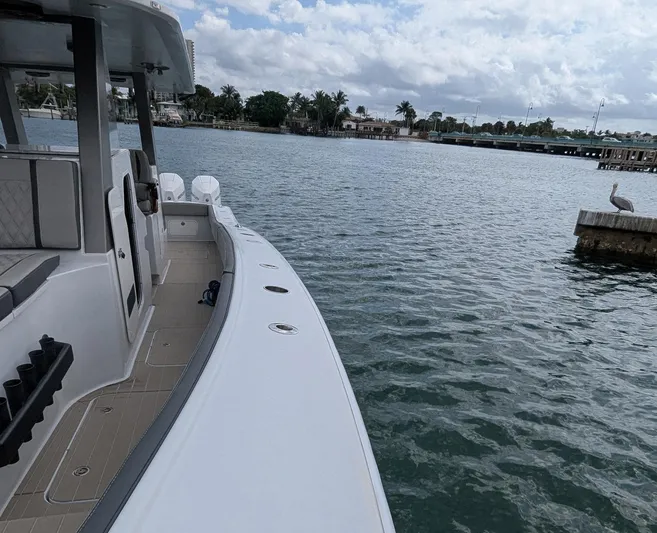  Yacht Photos Pics 2021 Vela 368 Center Console boat on calm waters near a dock.