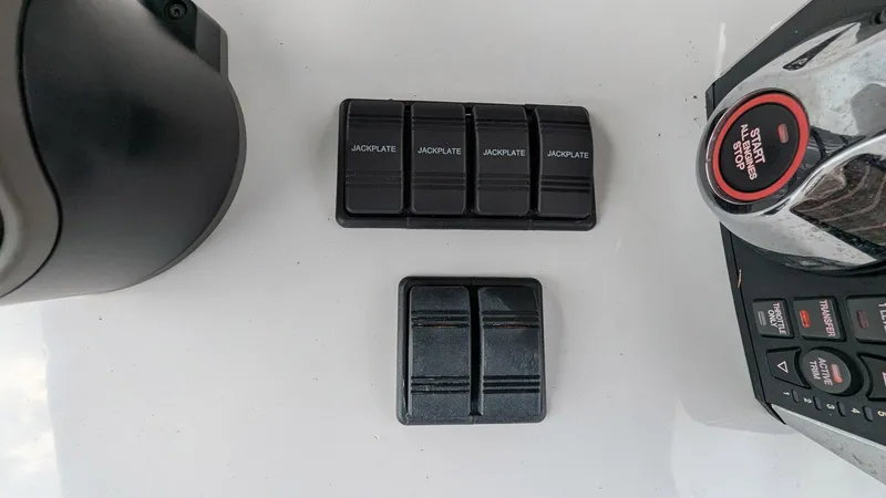  Yacht Photos Pics Control panel of a 2021 Vela 368 Center Console boat with switches and buttons.